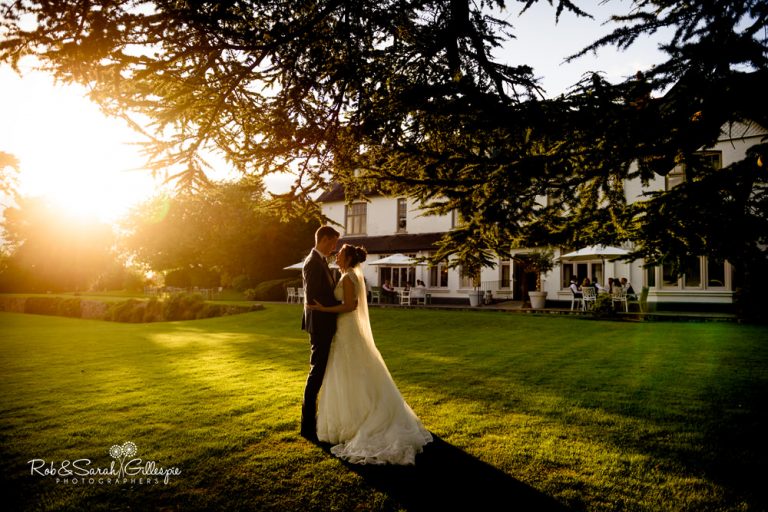Bride and groom at Ashton Lodge Country House in beautiful evening light
