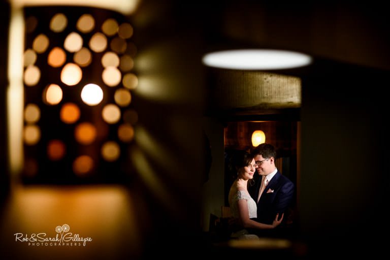 Bride and groom together inside old pub with beautiful light