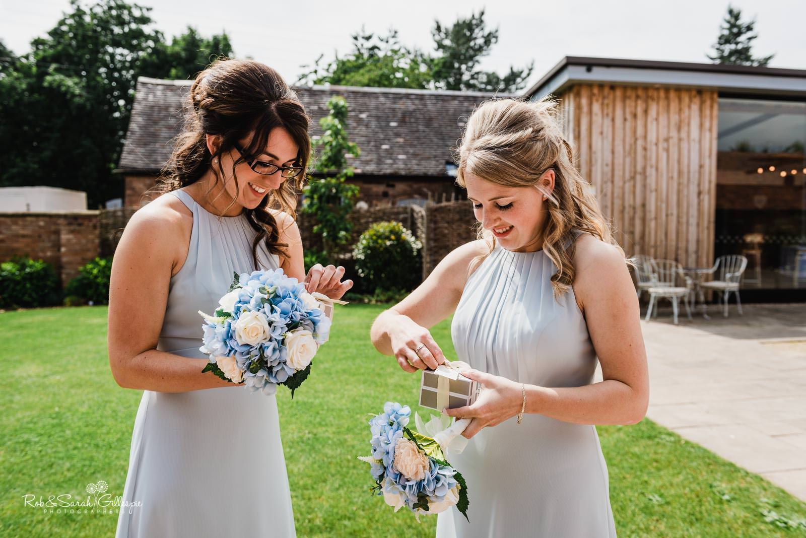 Bridesmaids open presents at Wedding ceremony at Swallows Nest Barn wedding