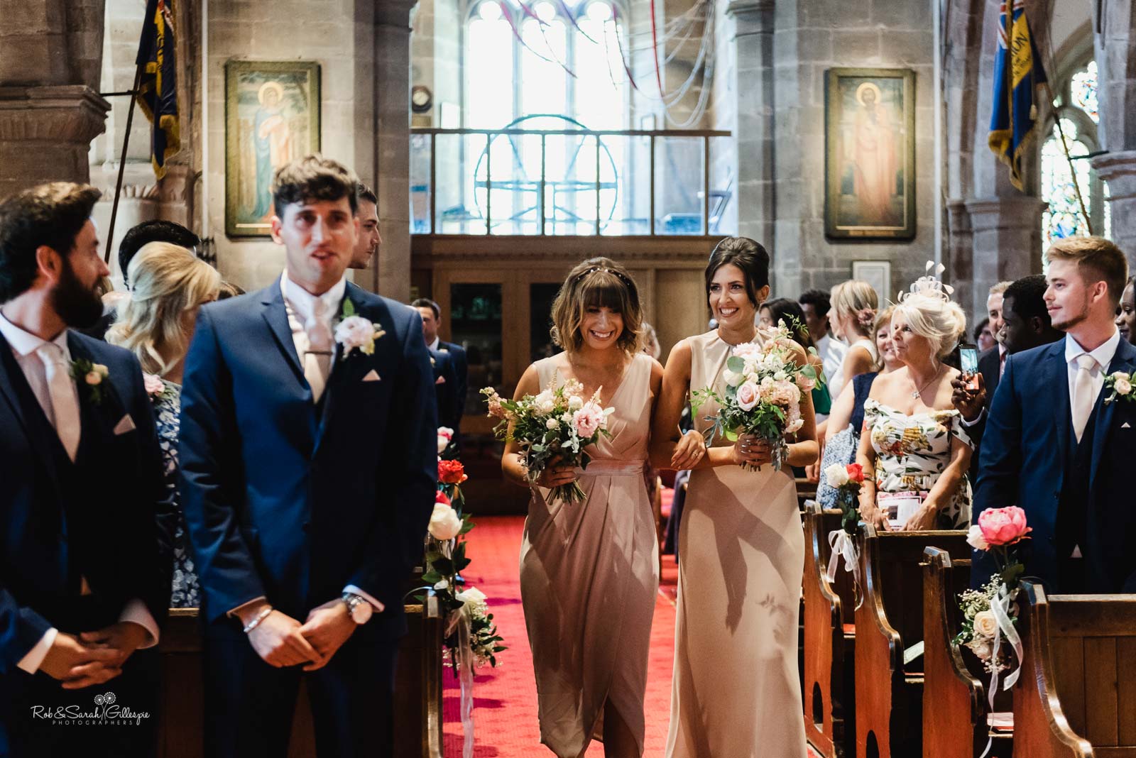 Bridesmaids enter Hampton-in-Arden church for wedding ceremony