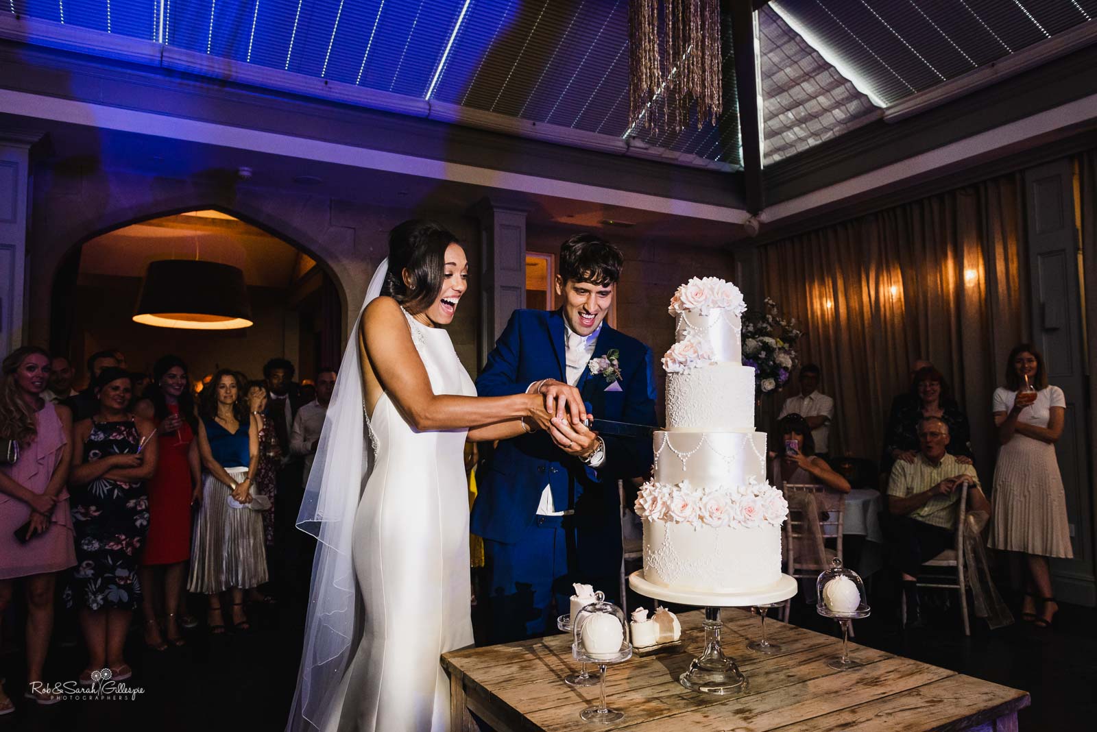 Bride and groom cut wedding caker at Hampton Manor