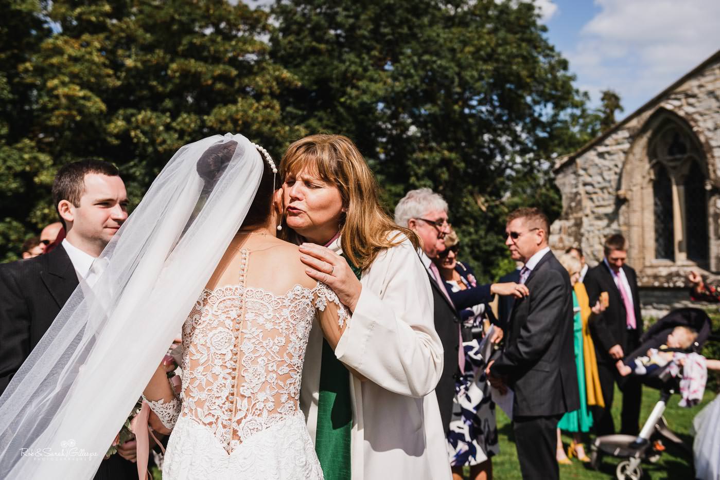 Wedding guests congratulate bride and groom at Bourton-on-Dunsmore church