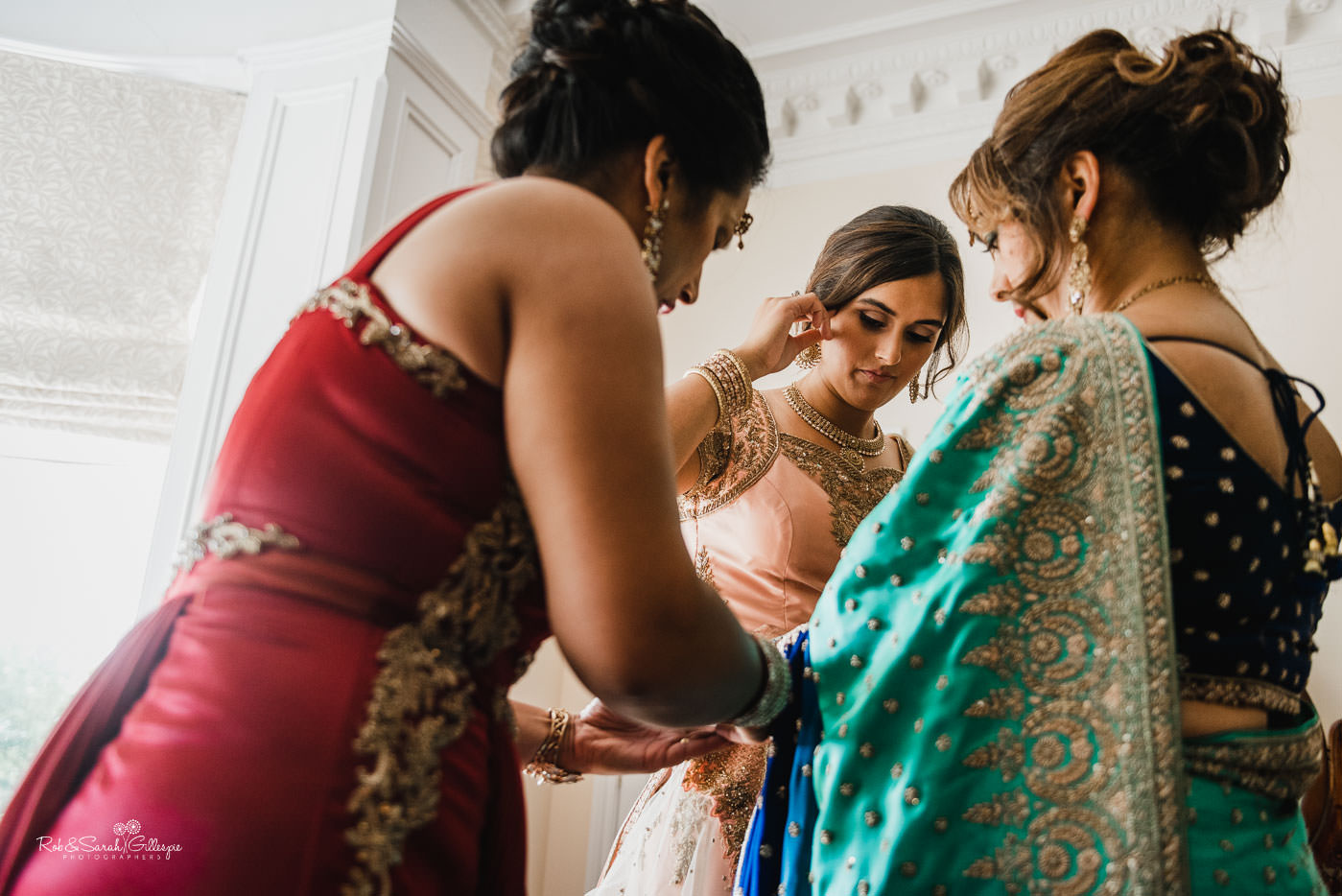 Bride and bridesmaids prepare for fusion wedding at Pendrell Hall