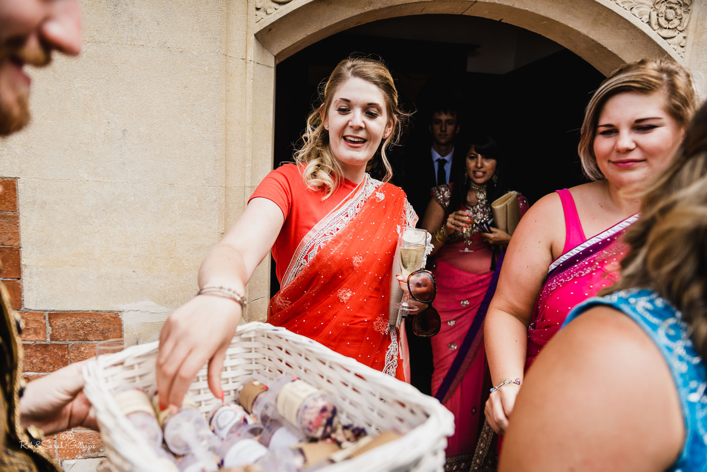 Guests take confetti at Pendrell Hall fusion wedding