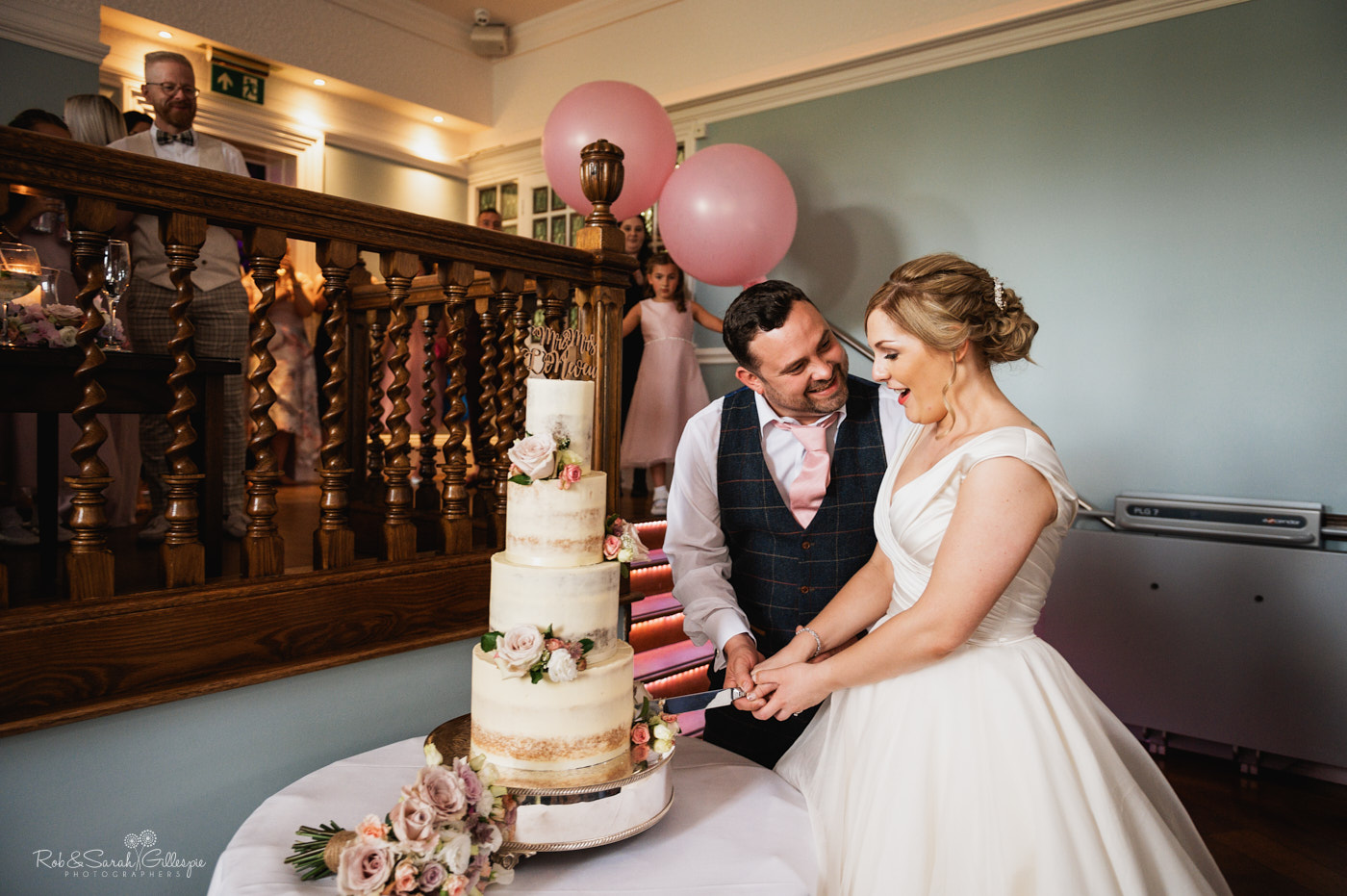 Bride and groom cut wedding cake at Pendrell Hall