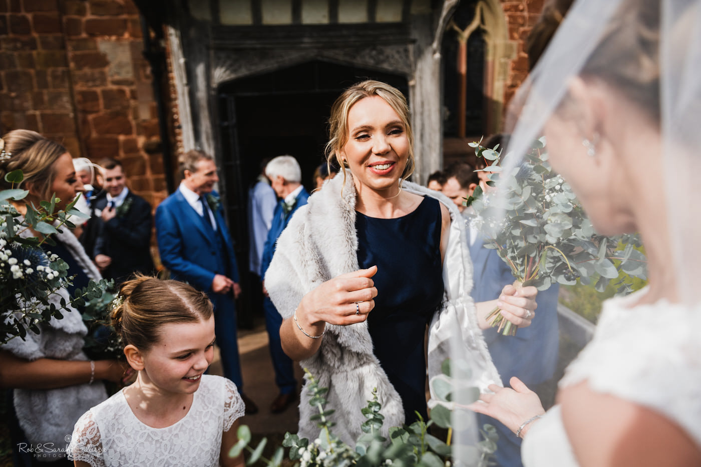 Wedding guests congratulate bride and groom at St Kenelm's church in Worcestershire