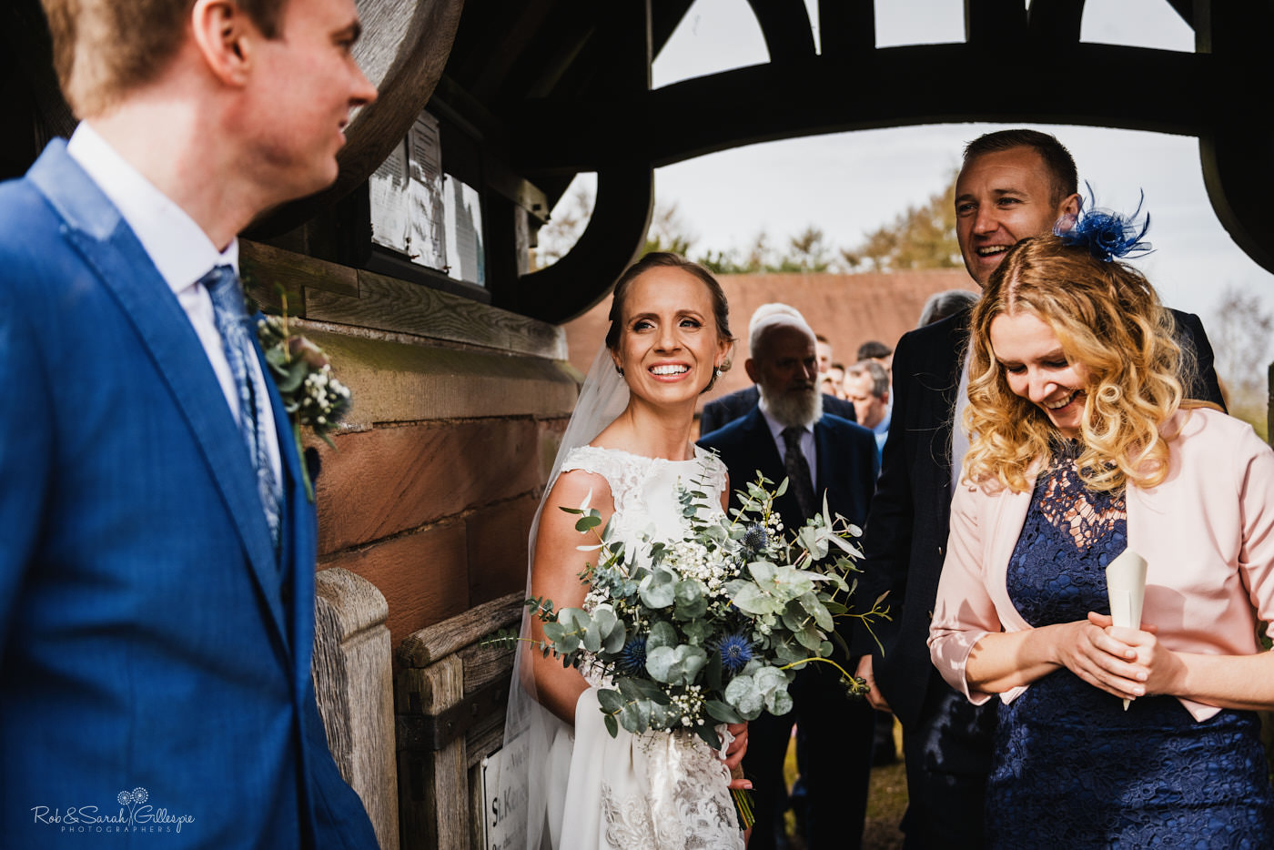 Wedding guests congratulate bride and groom at St Kenelm's church in Worcestershire