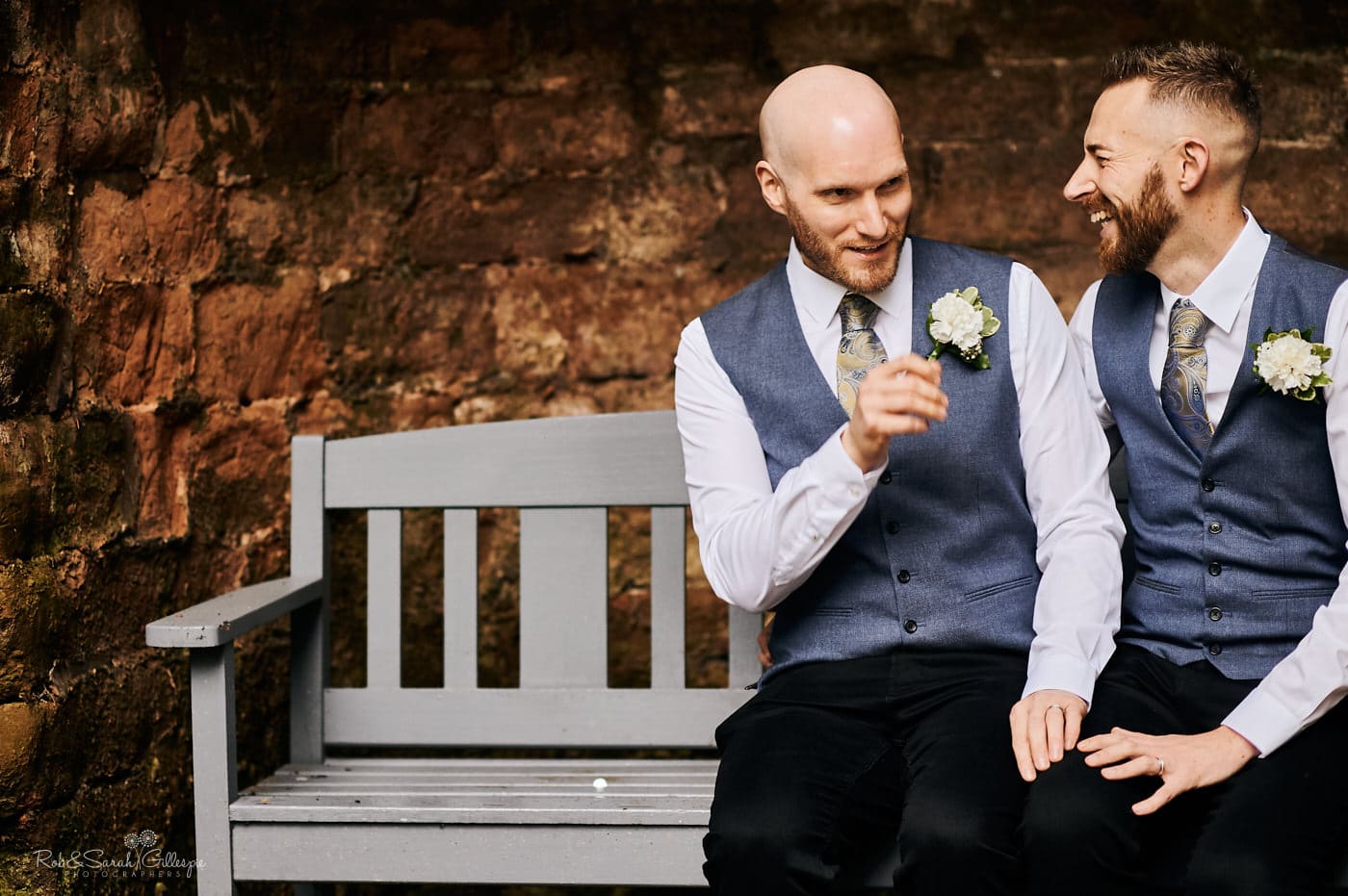 Two grooms sitting on bench at Moor Hall Hotel