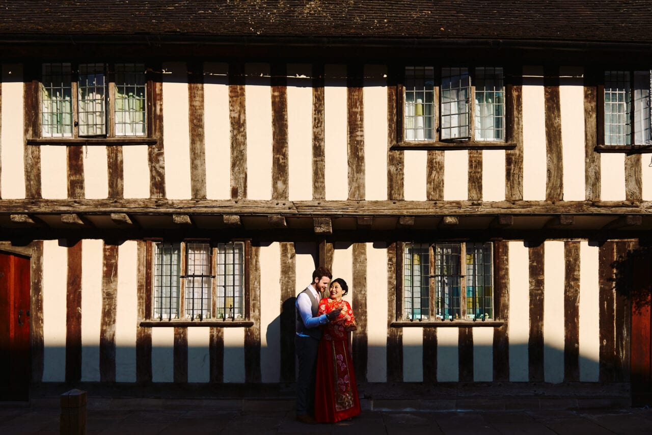 Bride and groom cuddled up at old building in Stratford upon Avon