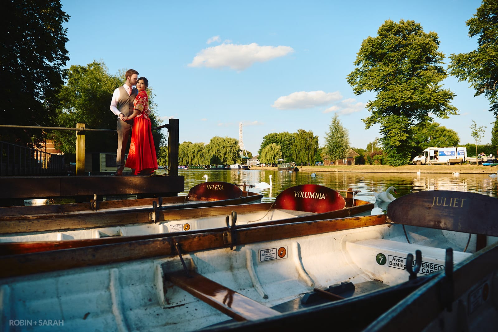 Bride and groom with boats on river Avon in Stratford