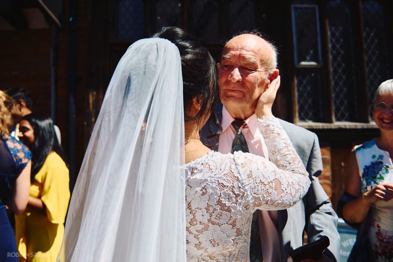 Bride hugs elderly wedding guest