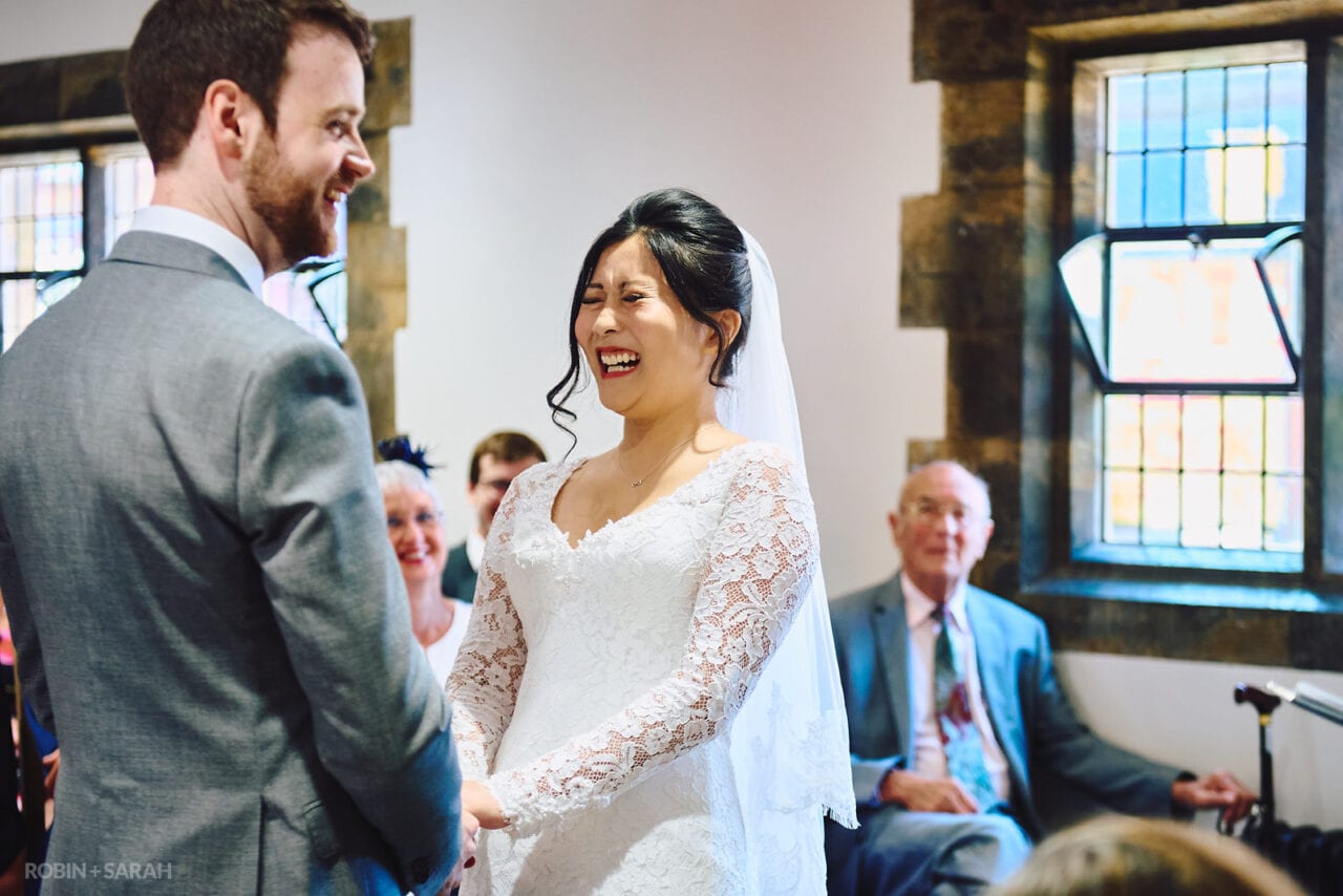 Bride laughing during wedding at The Henley Room