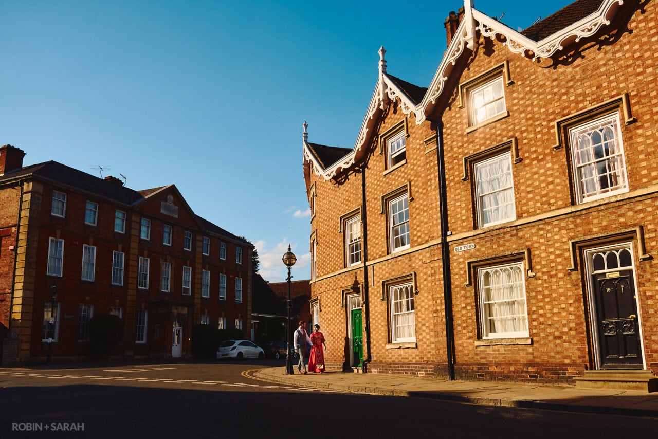 Bride and groom walk through Stratford upon Avon
