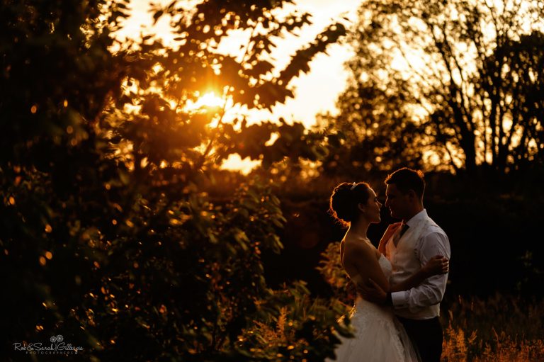 Bride and groom at home wedding with beautiful sunset