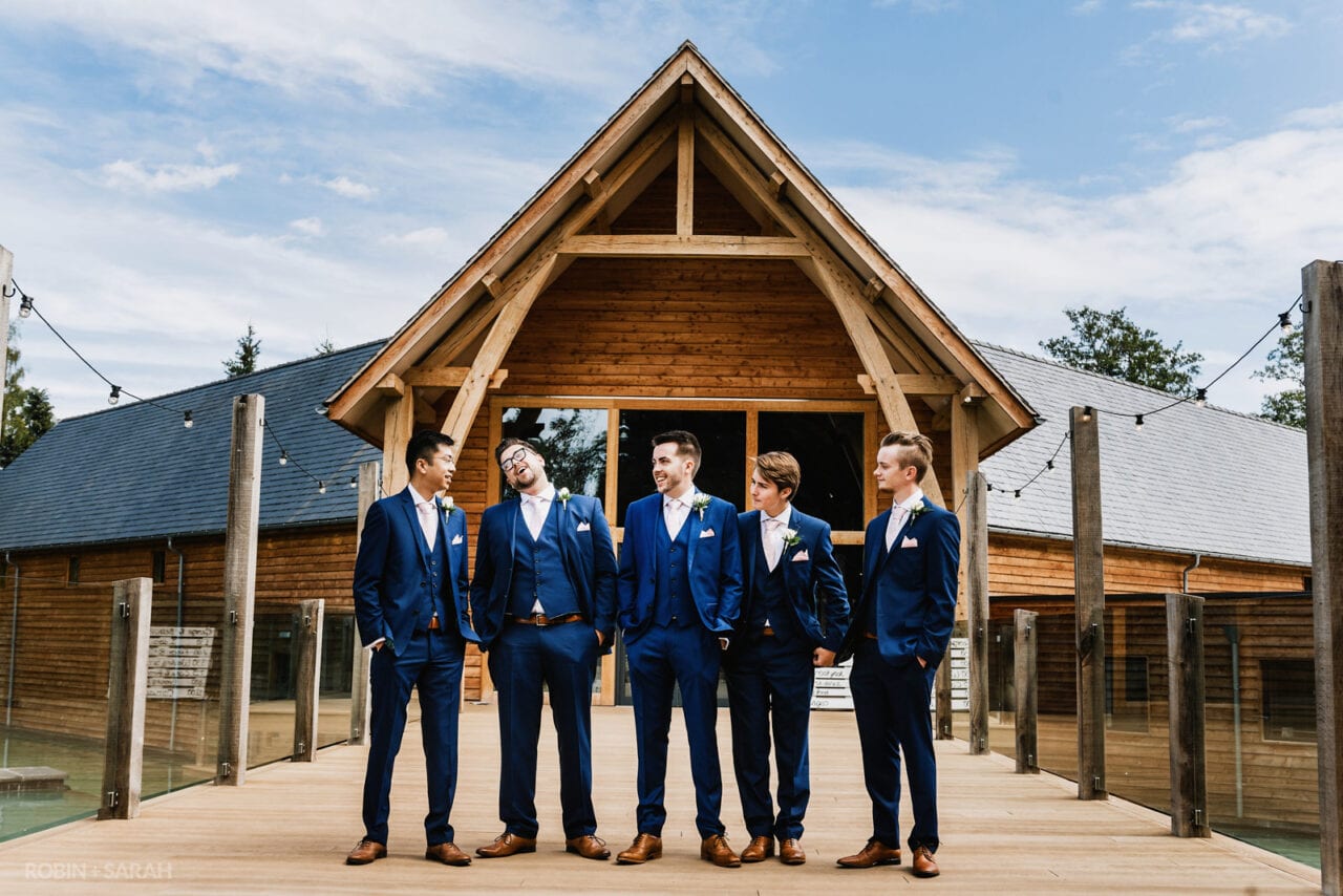 Group of groom and groomsmen outside wedding venue