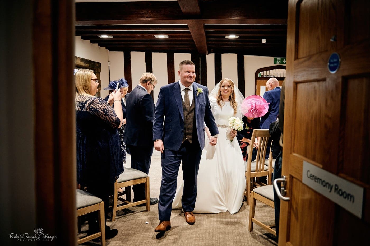 Bride and groom leave wedding ceremony in The Henley Room, Stratford-upon-Avon