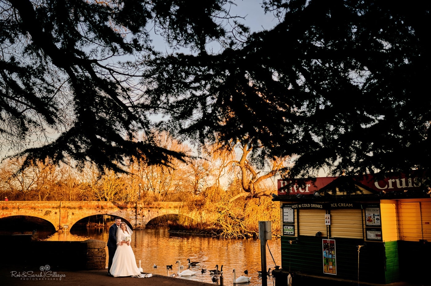 Bride and groom on bank of River Avon in beautiful winter light