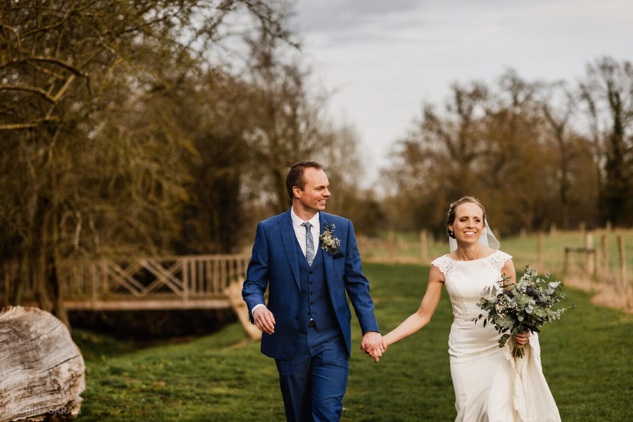 Bride and groom walking relaxed and happy in countryside