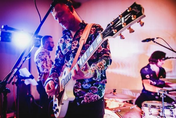 Guitarist and band play at wedding reception