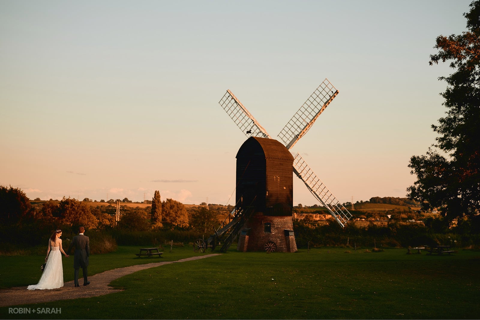 Bride and groom with old windmill