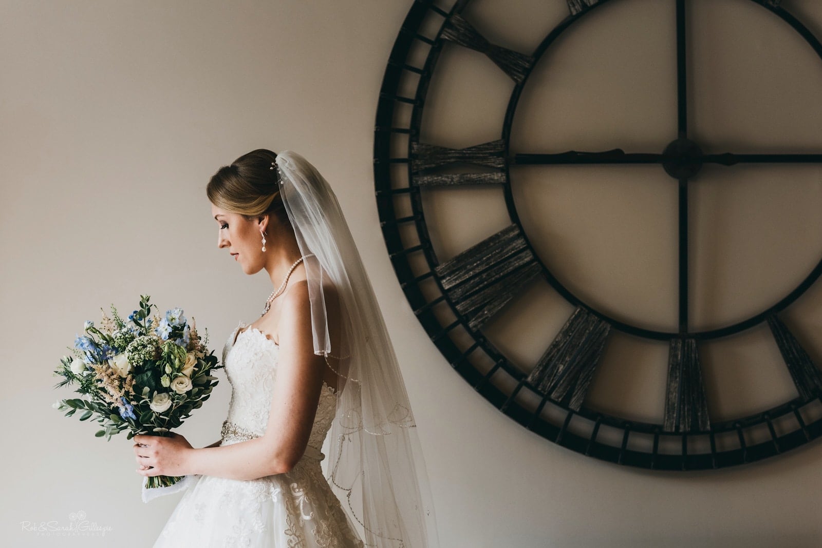 Bride portrait with large clock on wall