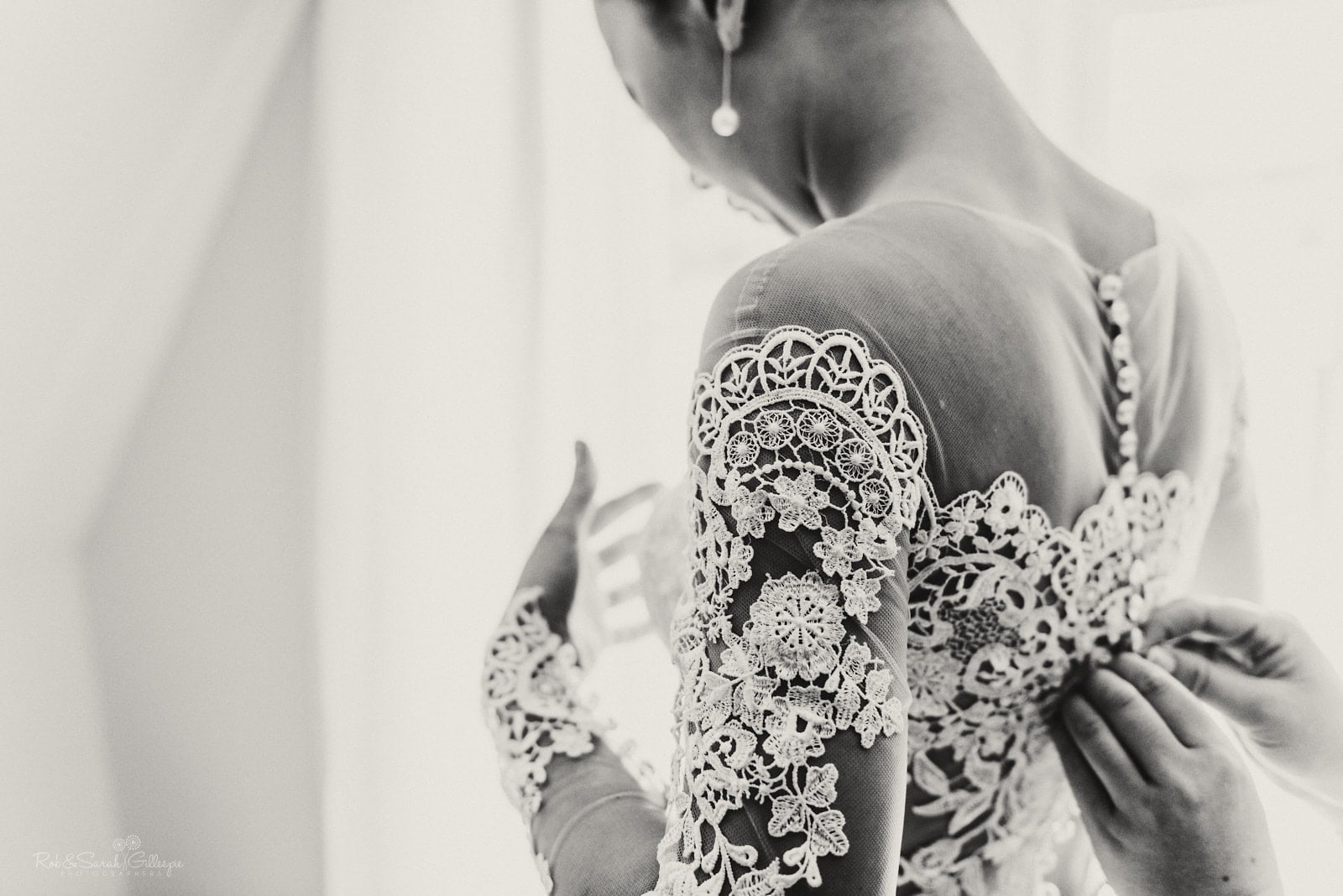 Detail of wedding dress as bride prepares