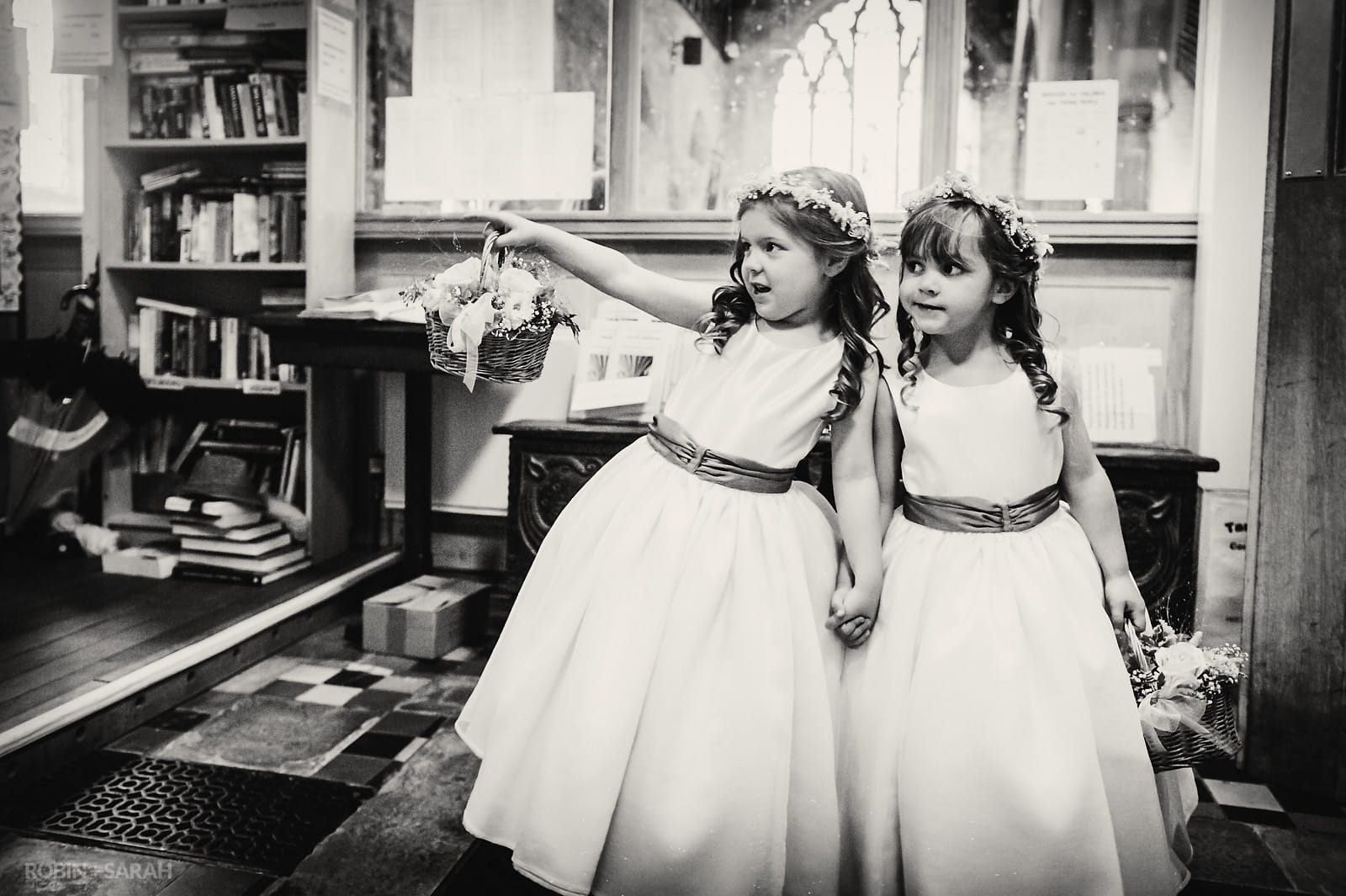 Two flowergirls waiting for bride in church