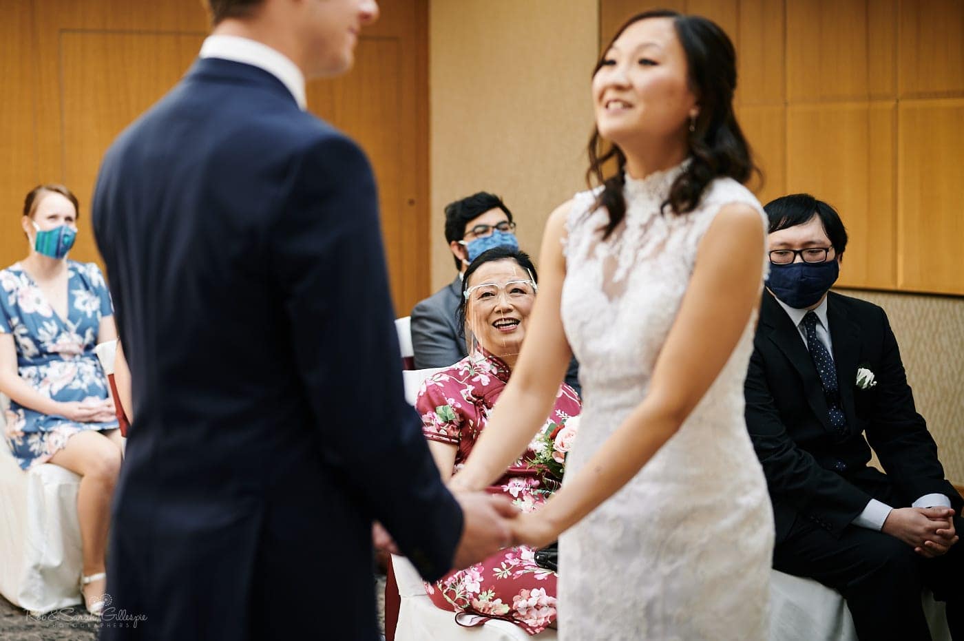 Bride's mum watches as bride and groom exchange wedding vows
