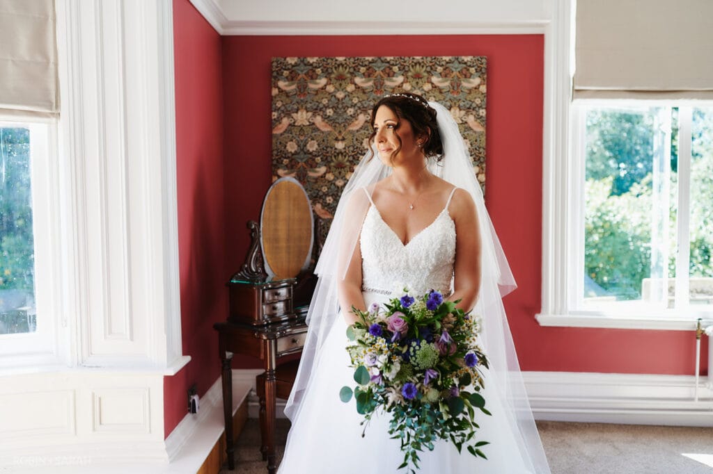 Portrait of bride in Strawberry Thief bedroom at Pendrell Hall