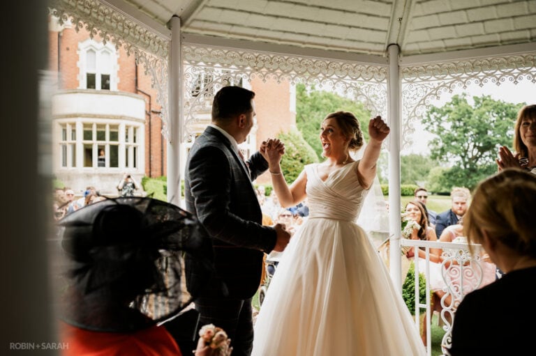 Bride punches air during outdoor wedding ceremony at Pendrell Hall
