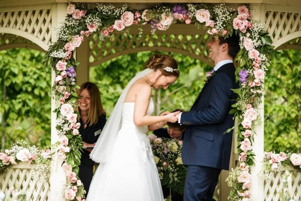 Bride and groom laughing during wedding ceremony at Warwick House