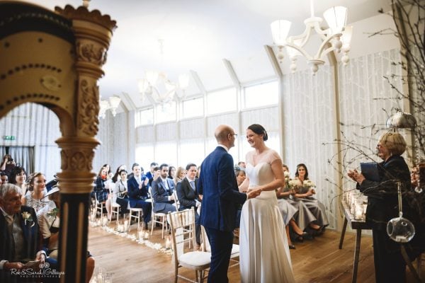 Bride and groom exchange wedding vows at Hampton Manor