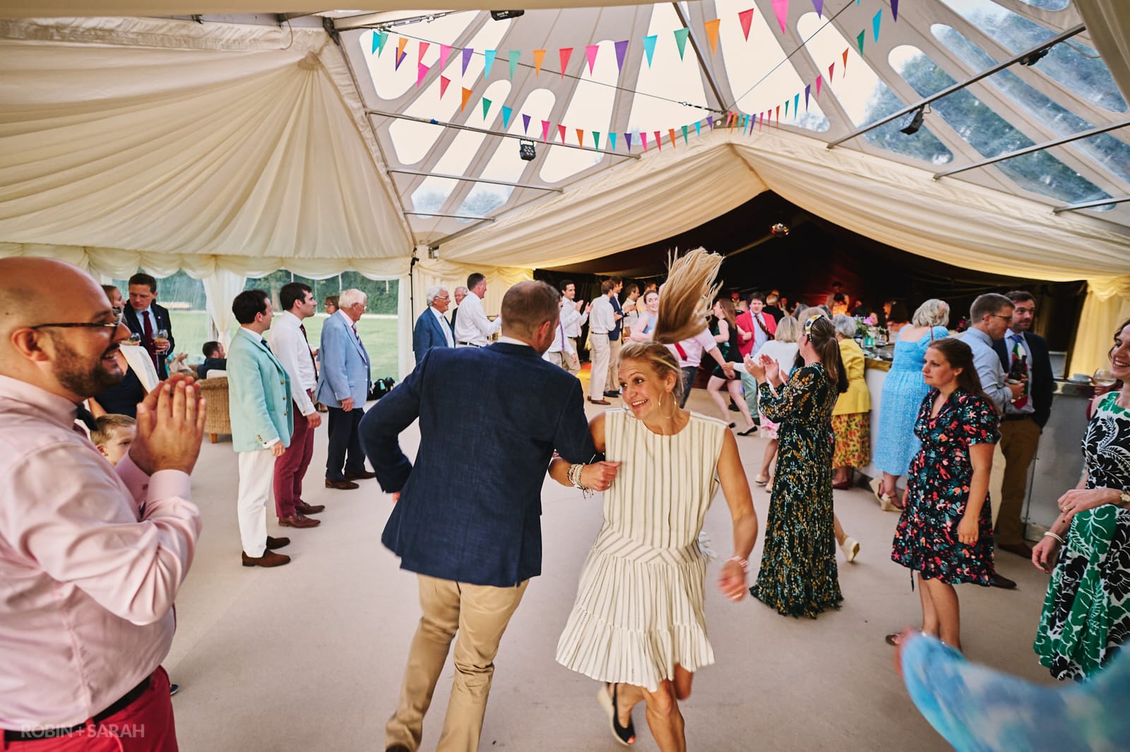 Wedding guests dance to ceilidh at wedding reception