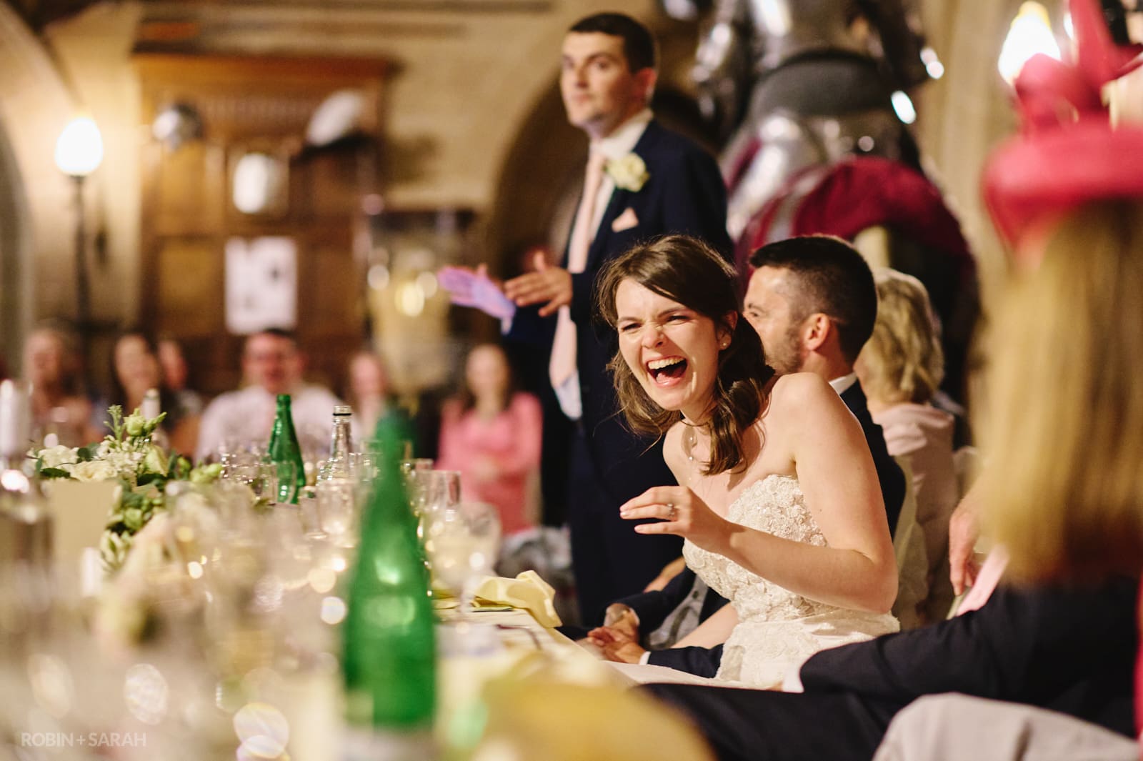 Bride laughing hysterically during wedding speeches