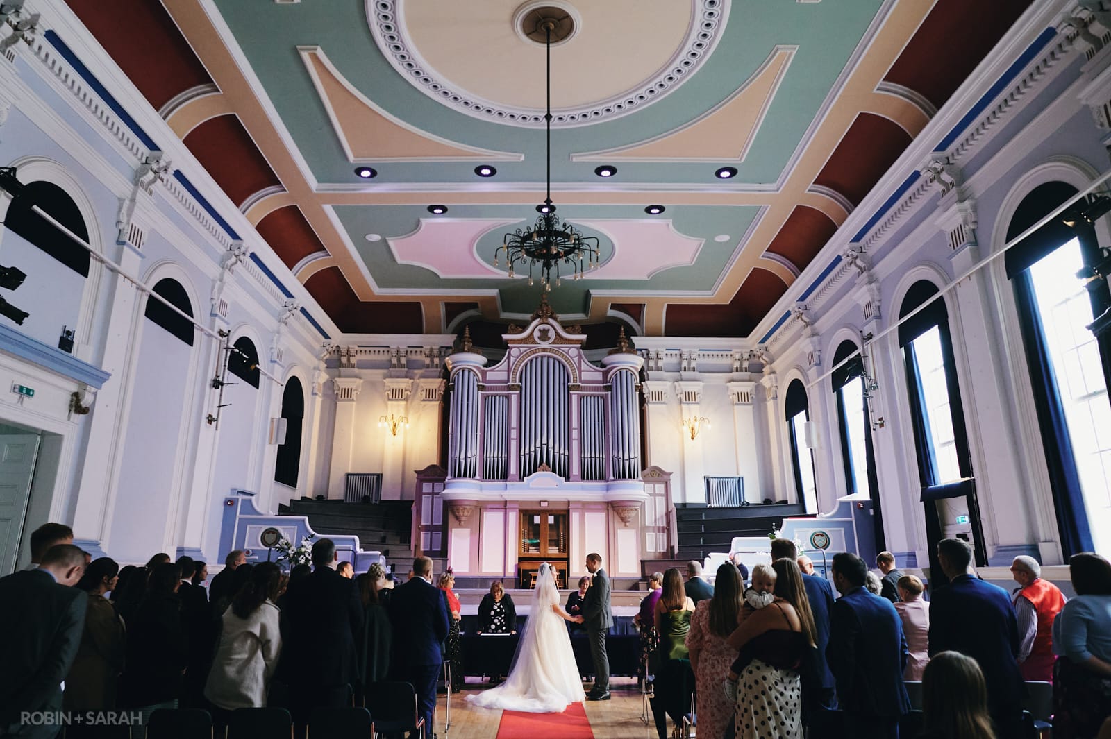 Bride and groom exchange wedding vows in beautiful old town hall