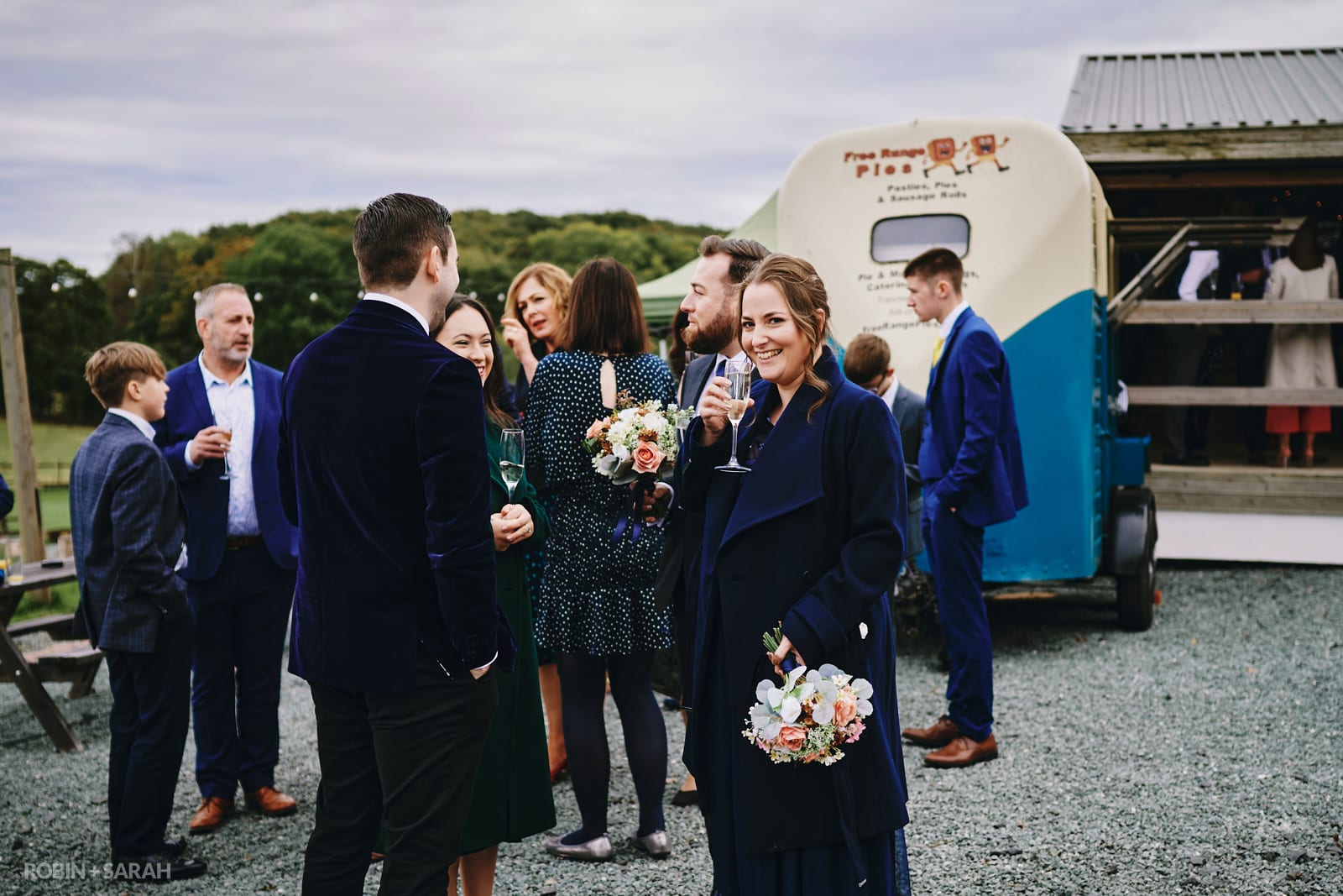 Wedding guests relax and chat outside at The Barn at Dinthill