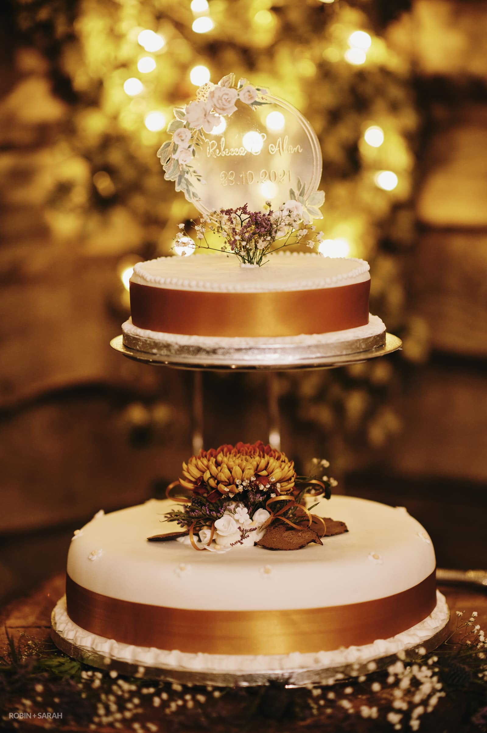 Wedding cake with white icing and copper coloured banding