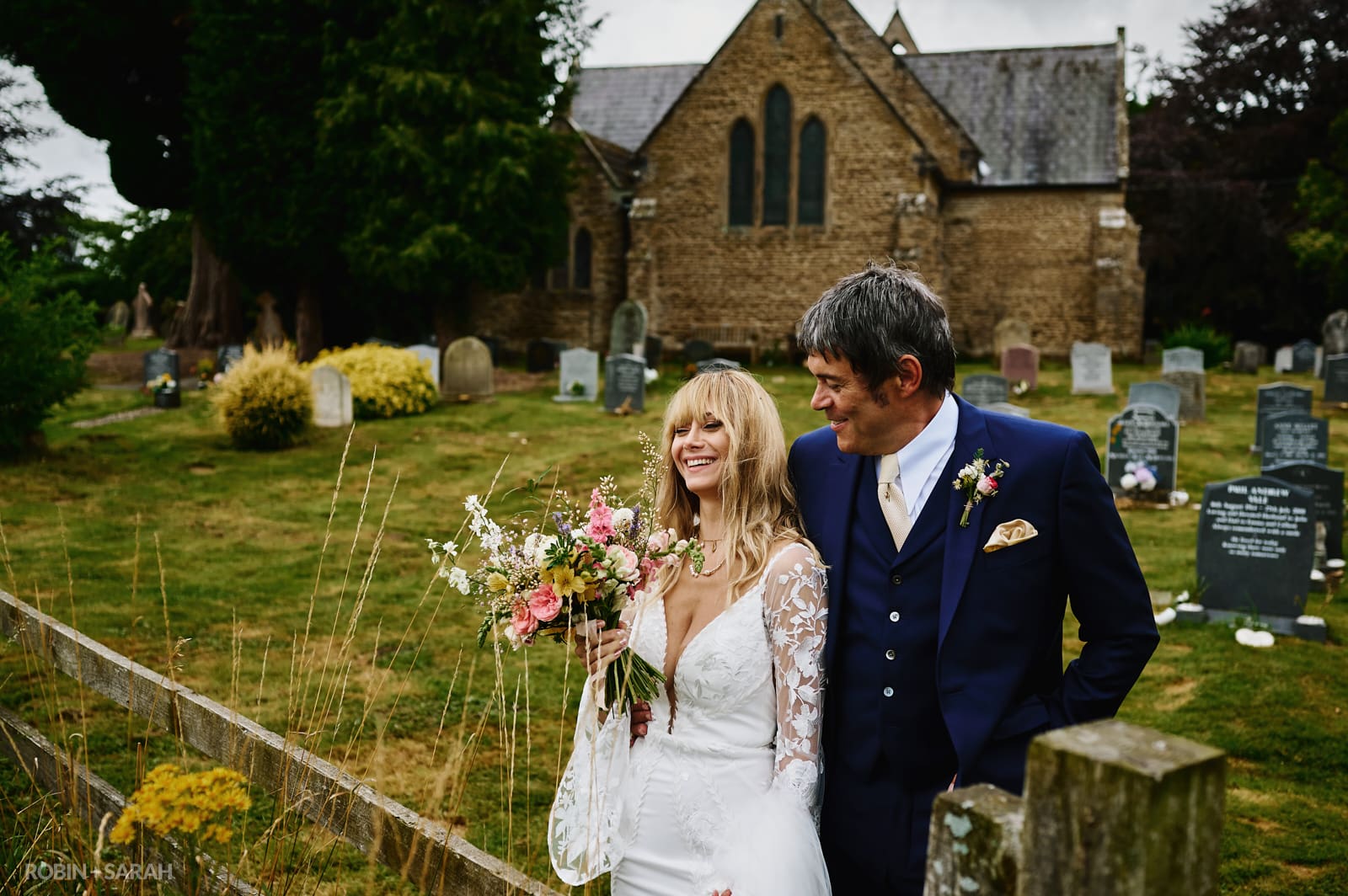 Bride and groom together in churchyard at Far Forest church in Worcestershire