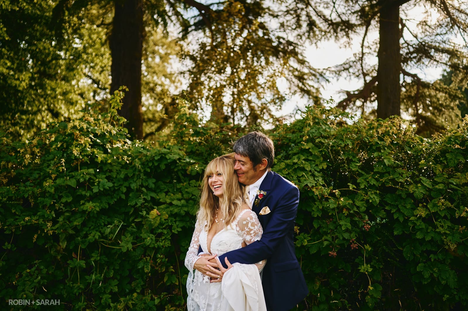 Bride and groom cuddle at Forest's Edge wedding venue in Far Forest, Worcestershire