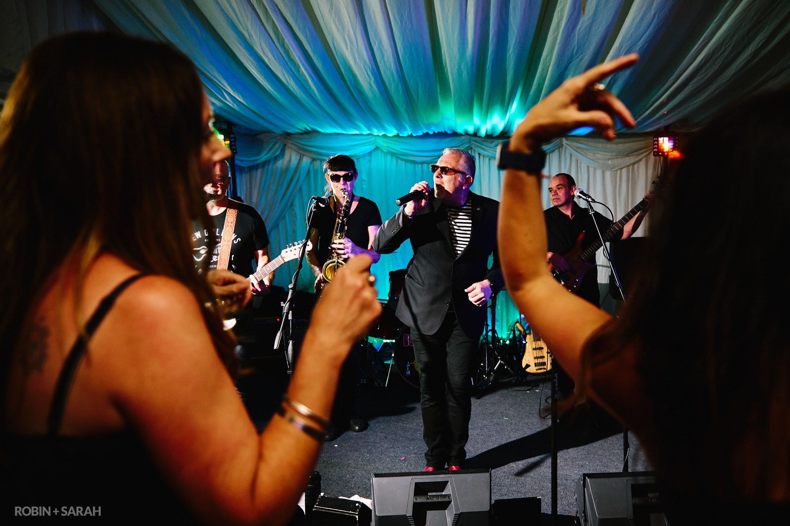 Live band play at wedding as guests dance