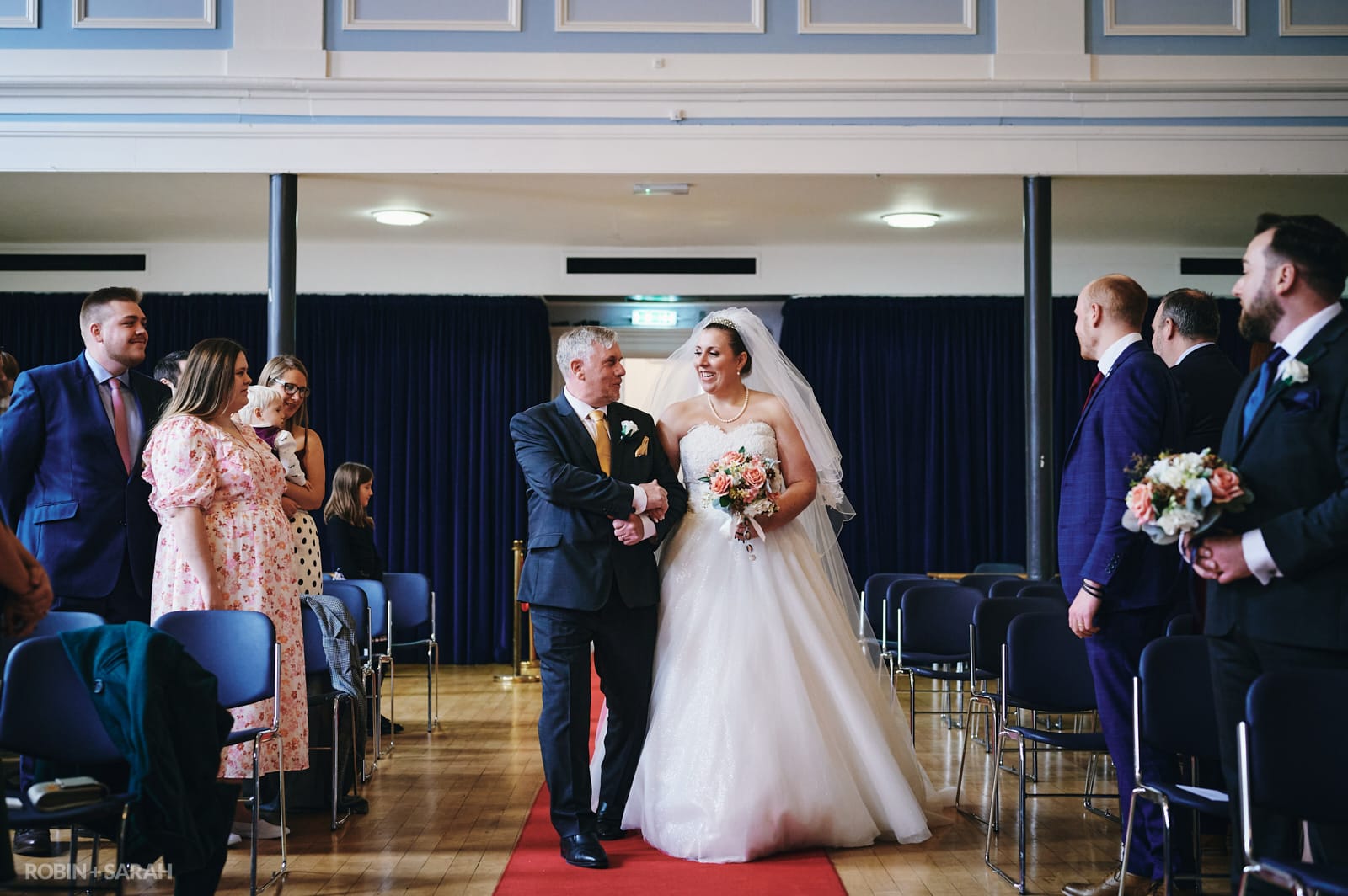 Bride and father walk up aisle together during civil ceremony at Kidderminster Town Hall