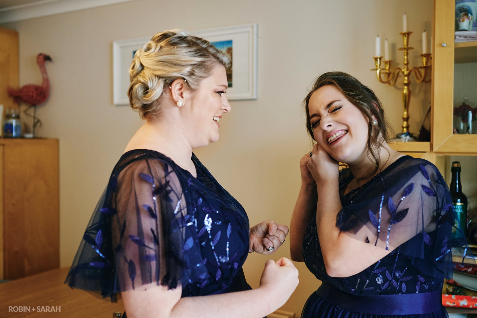 Bridesmaids share a laugh as they get ready for wedding