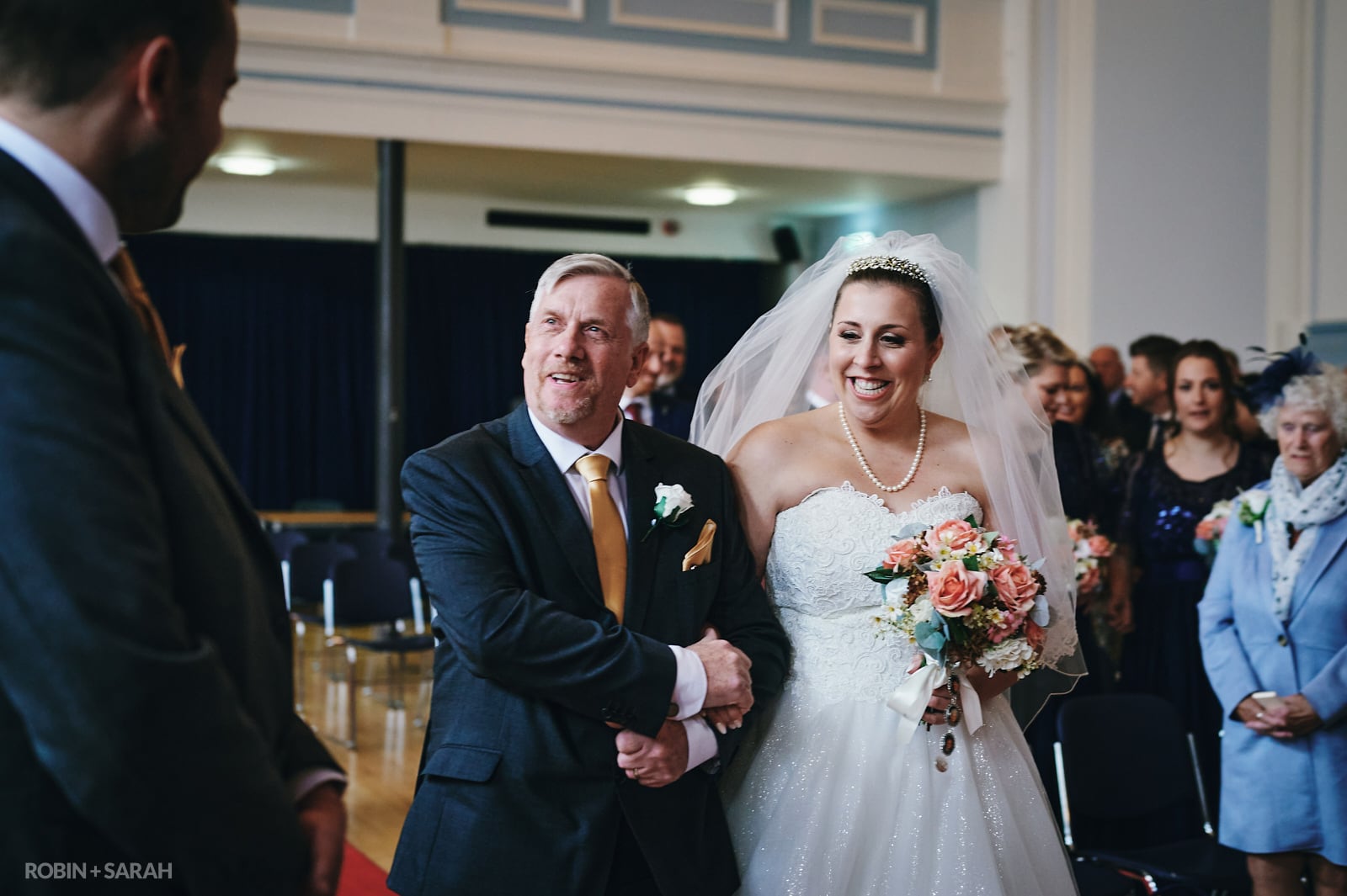 Bride and dad walk up aisle during wedding ceremony