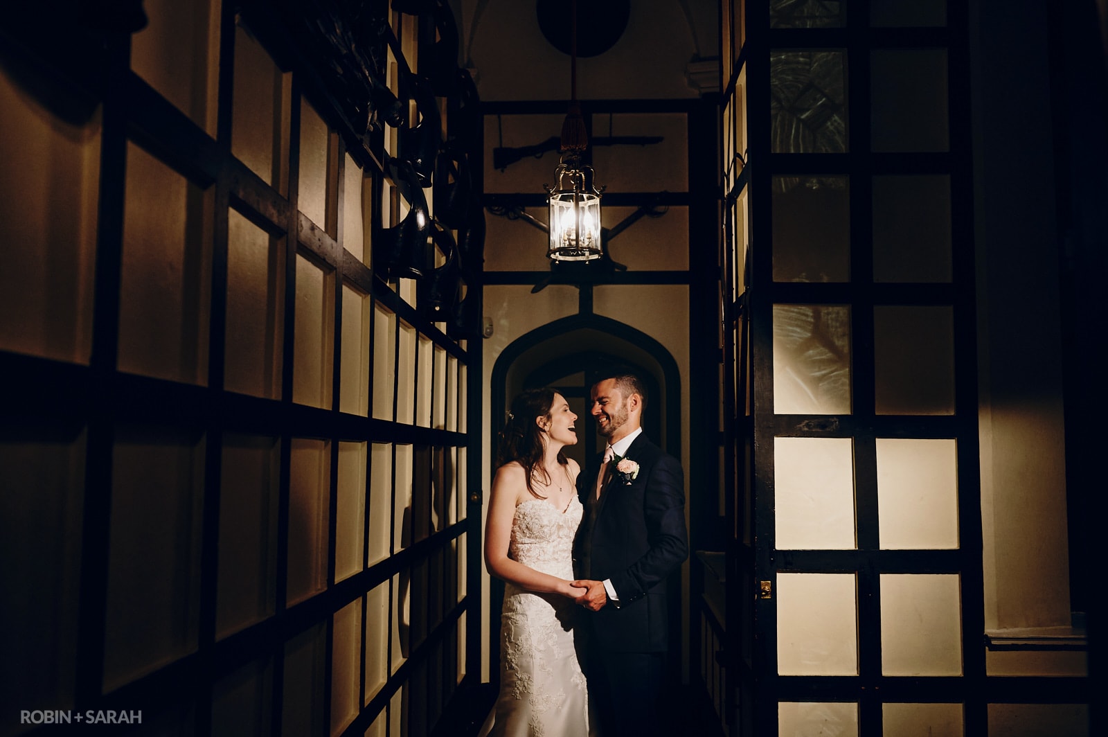 Bride and groom relax together in beautiful hallway at Warwick Castle