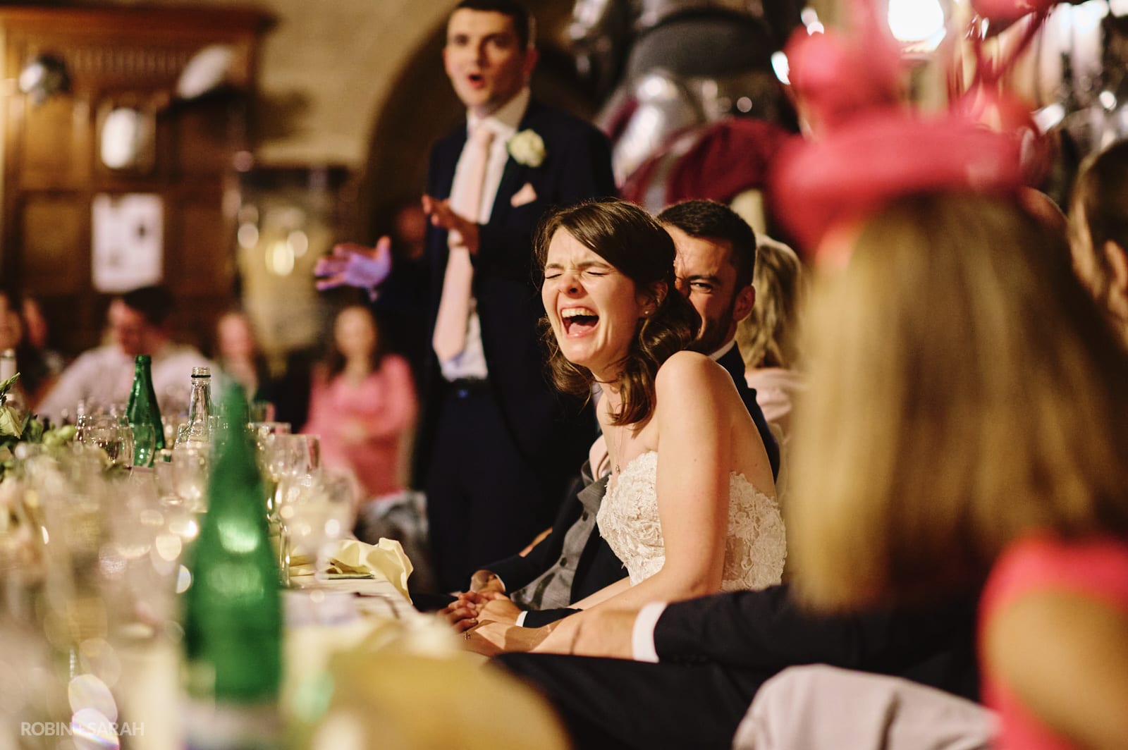 Bride laughs during best man's speech