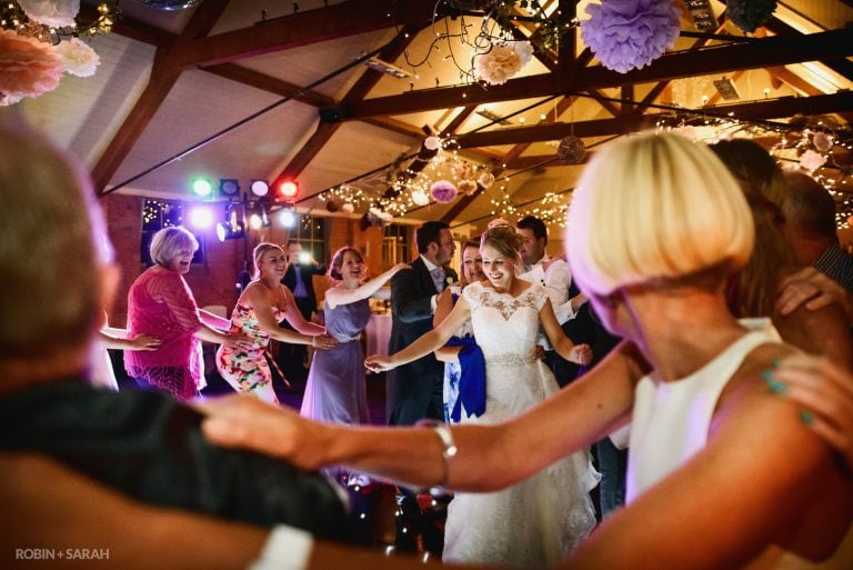 Bride dances with wedding guests at Gorcott Hall in Warwickshire