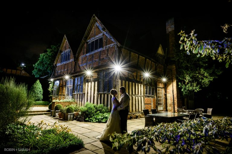 Bride and groom outside Gorcott Hall in Warwickshire at night