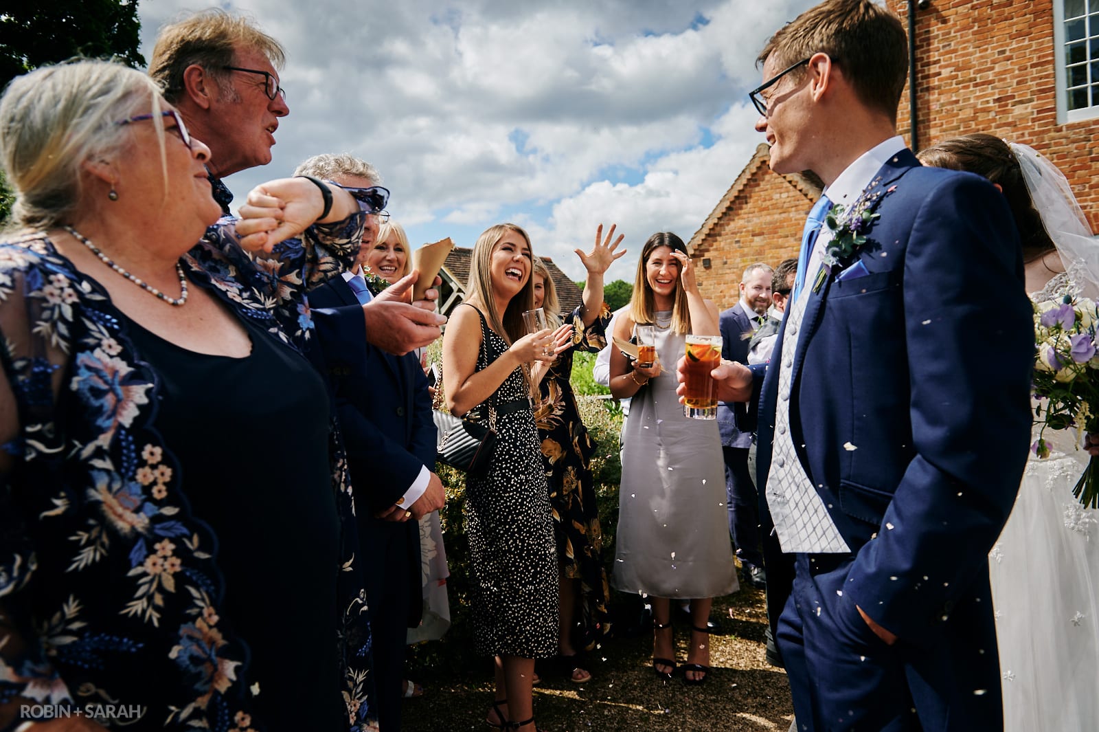 Bride and groom chat to guests as they arrive at wedding reception