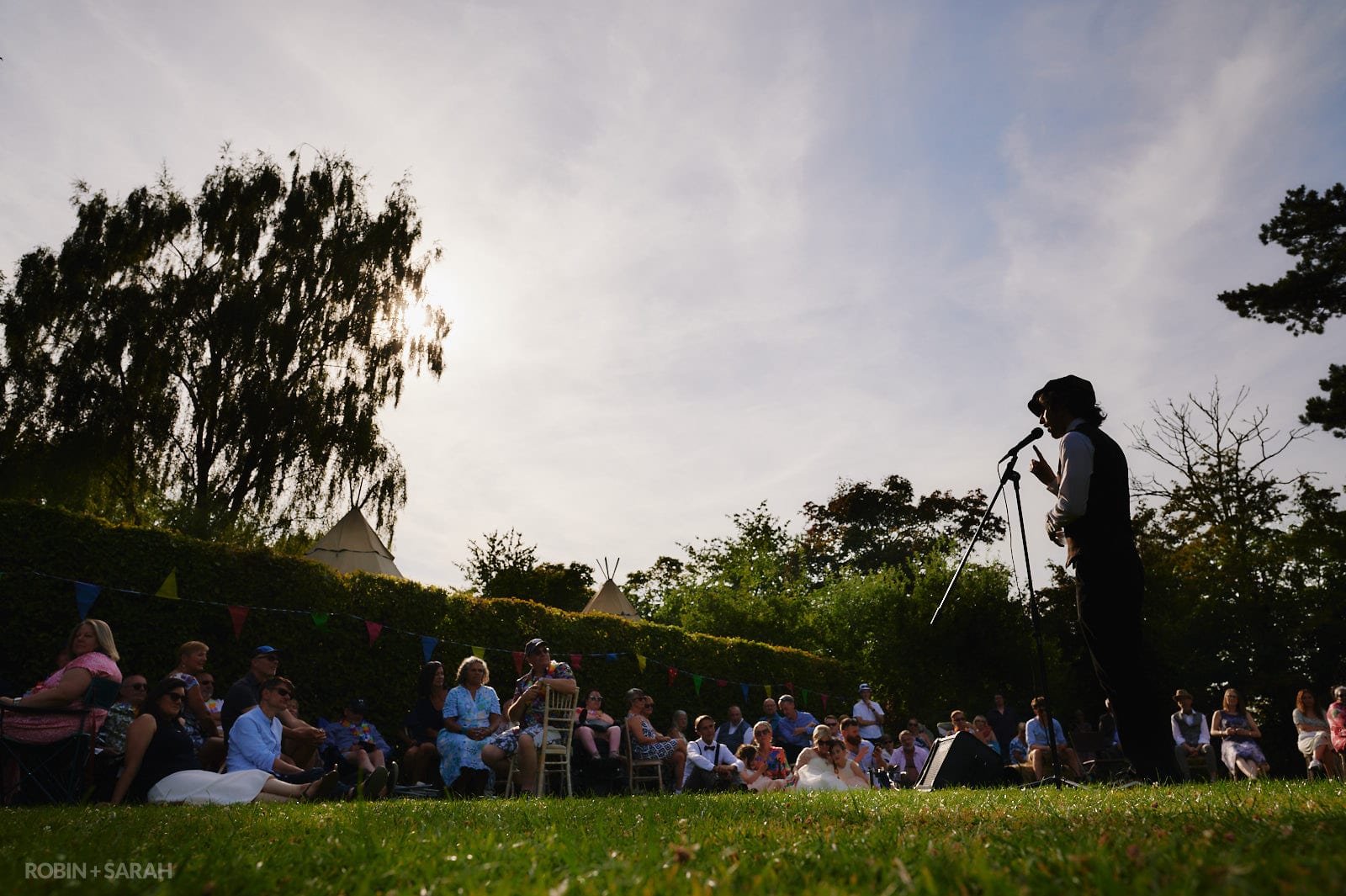 Poet Joe Cook delivers spoken word performance to wedding guests at Oakfield Gardens