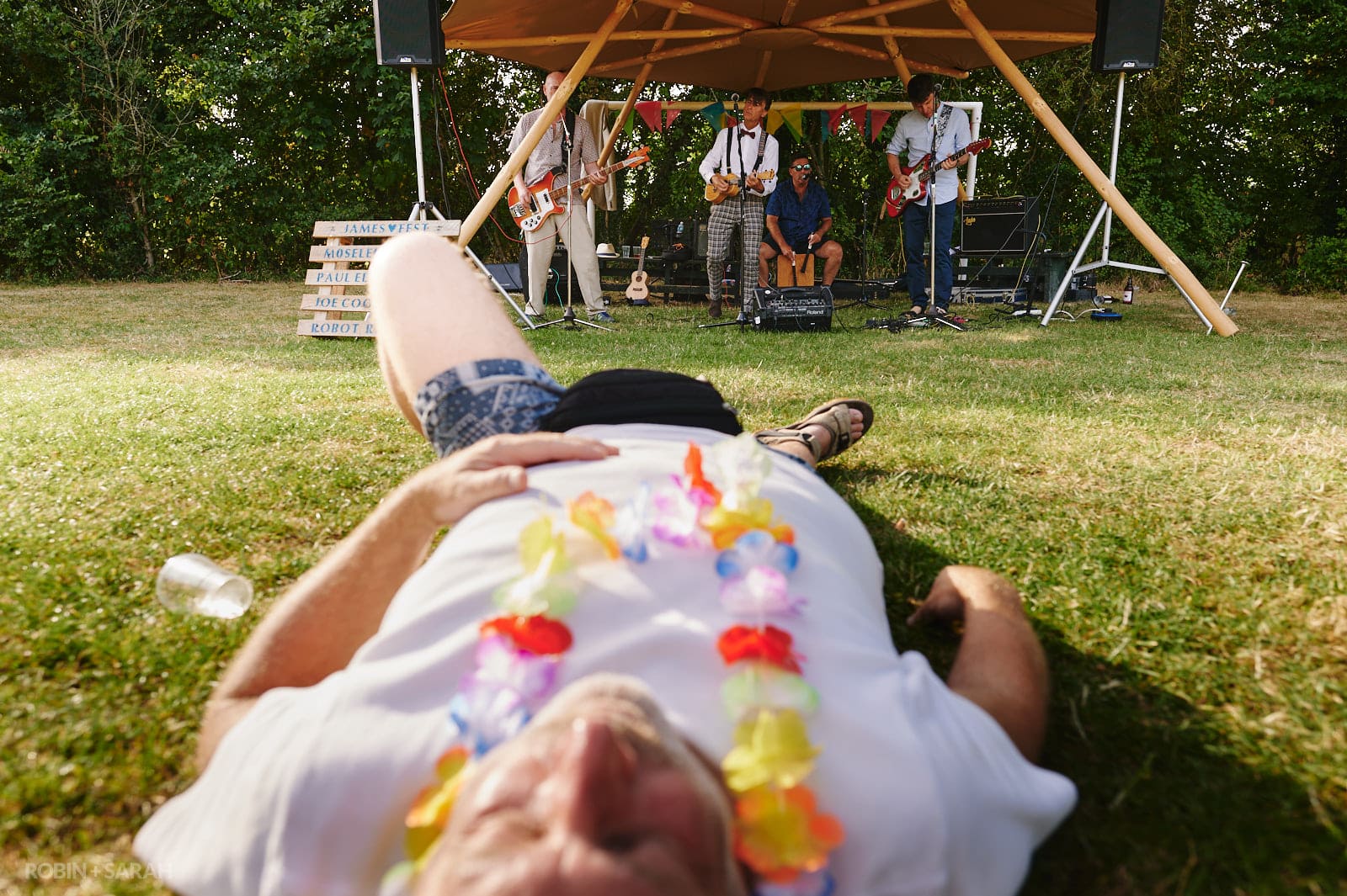 Wedding guests lies down as live band play